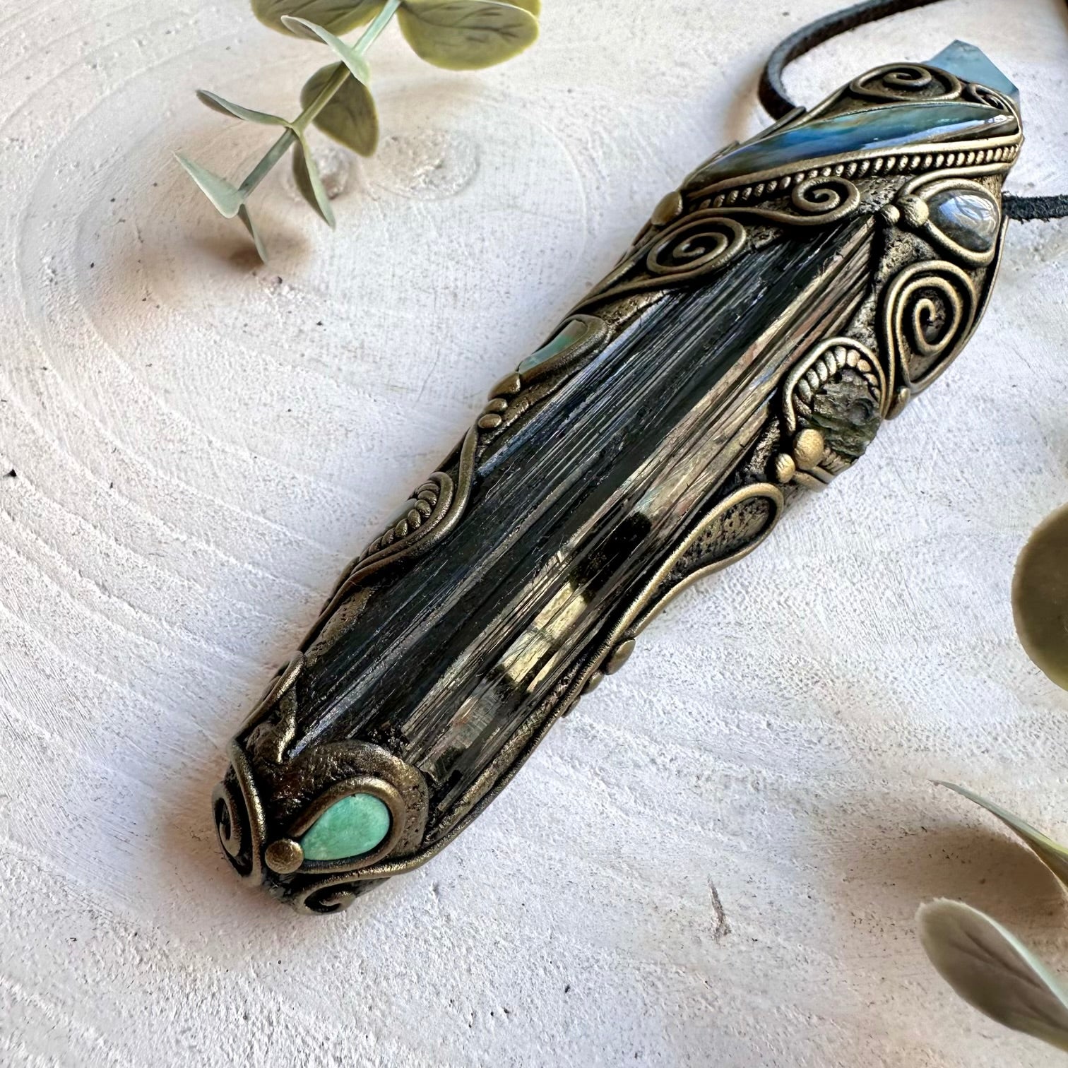 Handmade metaphysical jewelry showcasing Black Tourmaline, Turquoise with Clear Topaz and natural crystals.
