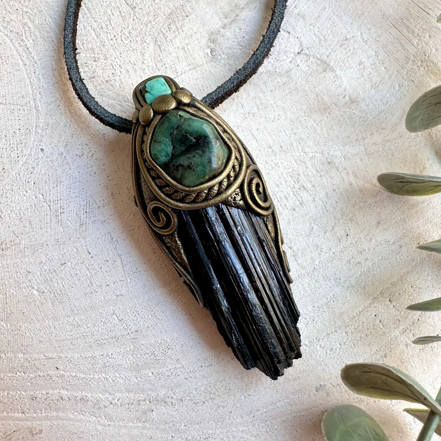 Handmade Black Tourmaline pendant necklace featuring Emerald and Tibetan Turquoise, a unique unisex crystal jewelry piece combining grounding black crystal with vibrant green and blue-green gemstones.