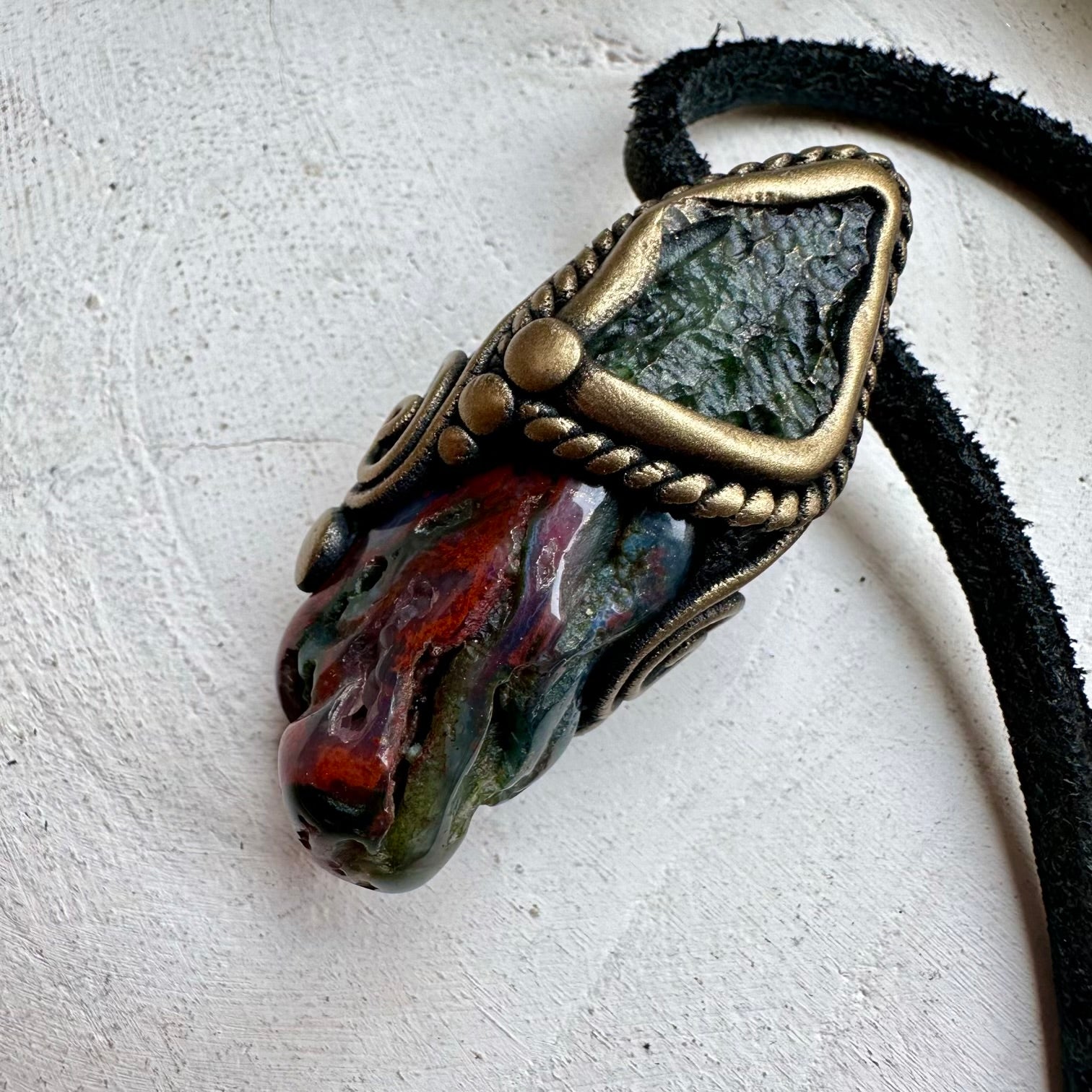 Natural bloodstone paired with moldavite in a necklace