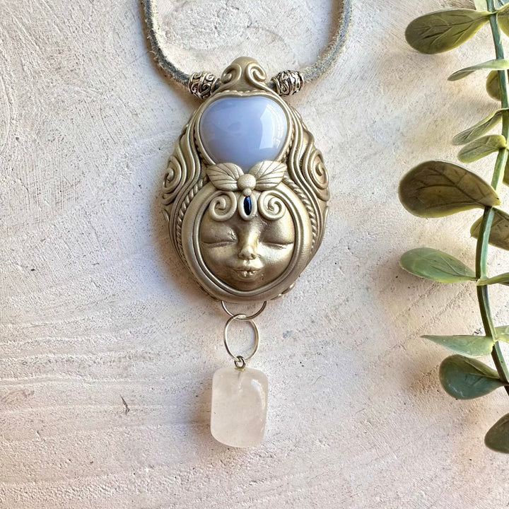 Handmade Blue Chalcedony Heart Goddess necklace featuring Clear Quartz and Blue Sapphire, a one of a kind spiritual gemstone jewelry piece combining soothing blue Chalcedony with luminous Quartz and deep blue Sapphire.