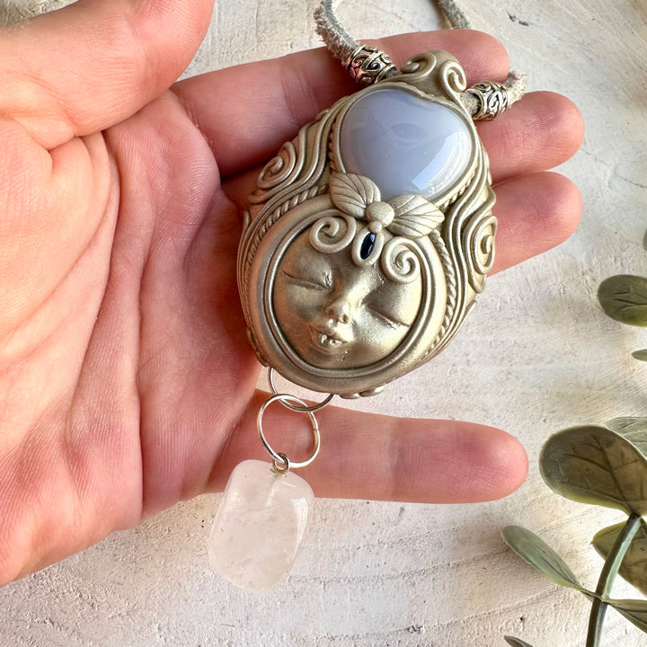 Blue Chalcedony Heart with Clear Quartz and Blue Sapphire Goddess necklace, handcrafted as unique spiritual gemstone jewelry.