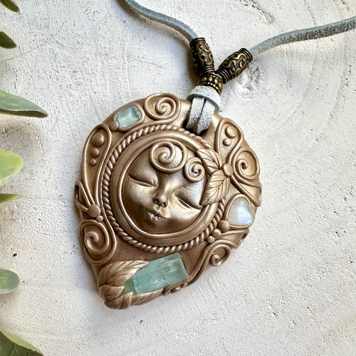 Aquamarine paired with rainbow moonstone heart and blue topaz in a necklace
