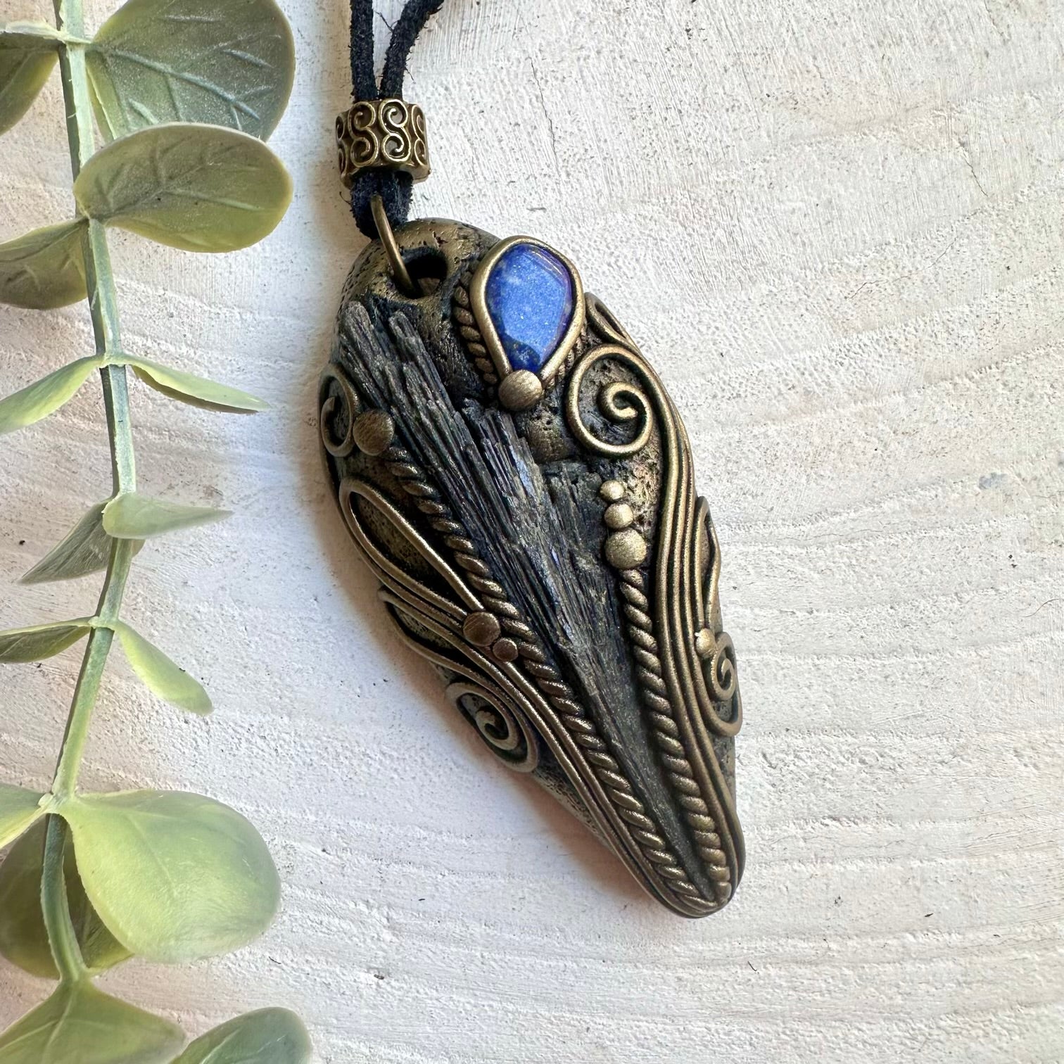 Spiritual gemstone necklace designed with Black Kyanite and Lapis Lazuli in an artisan setting.