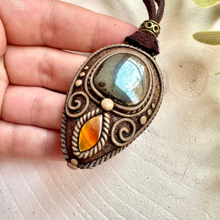 Beautiful gemstone pendant showcasing the colorful beauty of Boulder Opal and Ammolite.