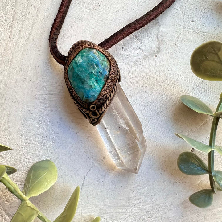 Close up of long clear quartz point and chrysocolla pendant