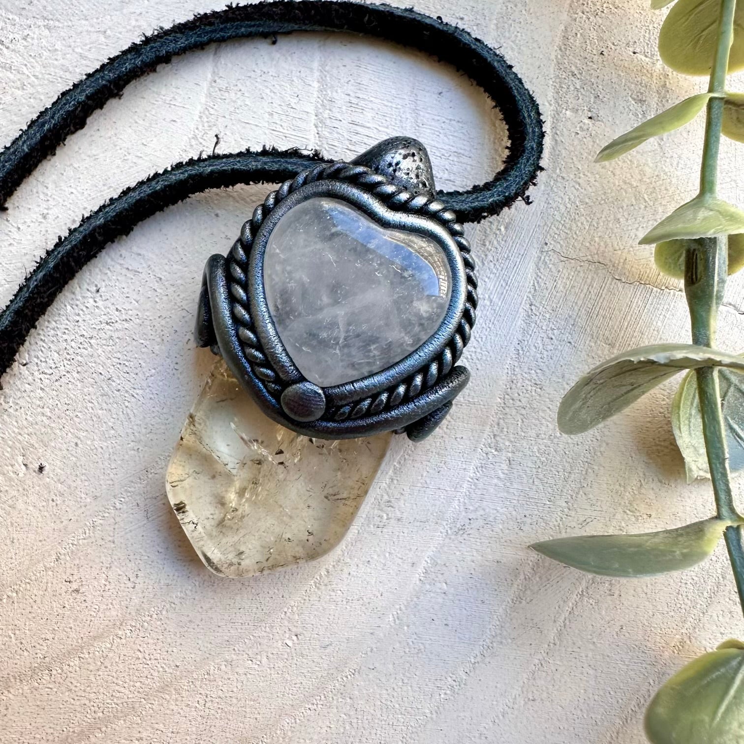 Natural citrine paired with a clear quartz heart in a pendant