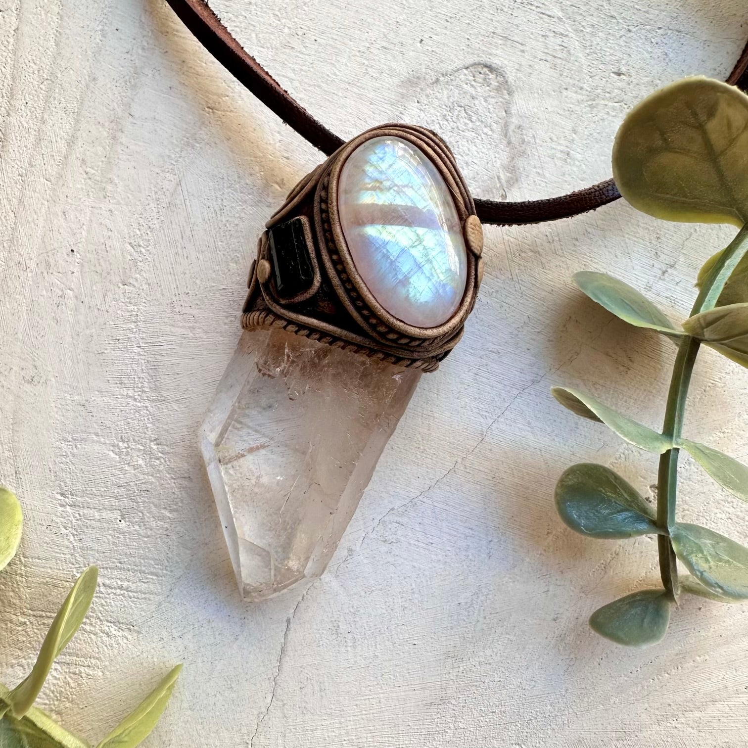 Clear quartz point paired with moonstone and black tourmaline