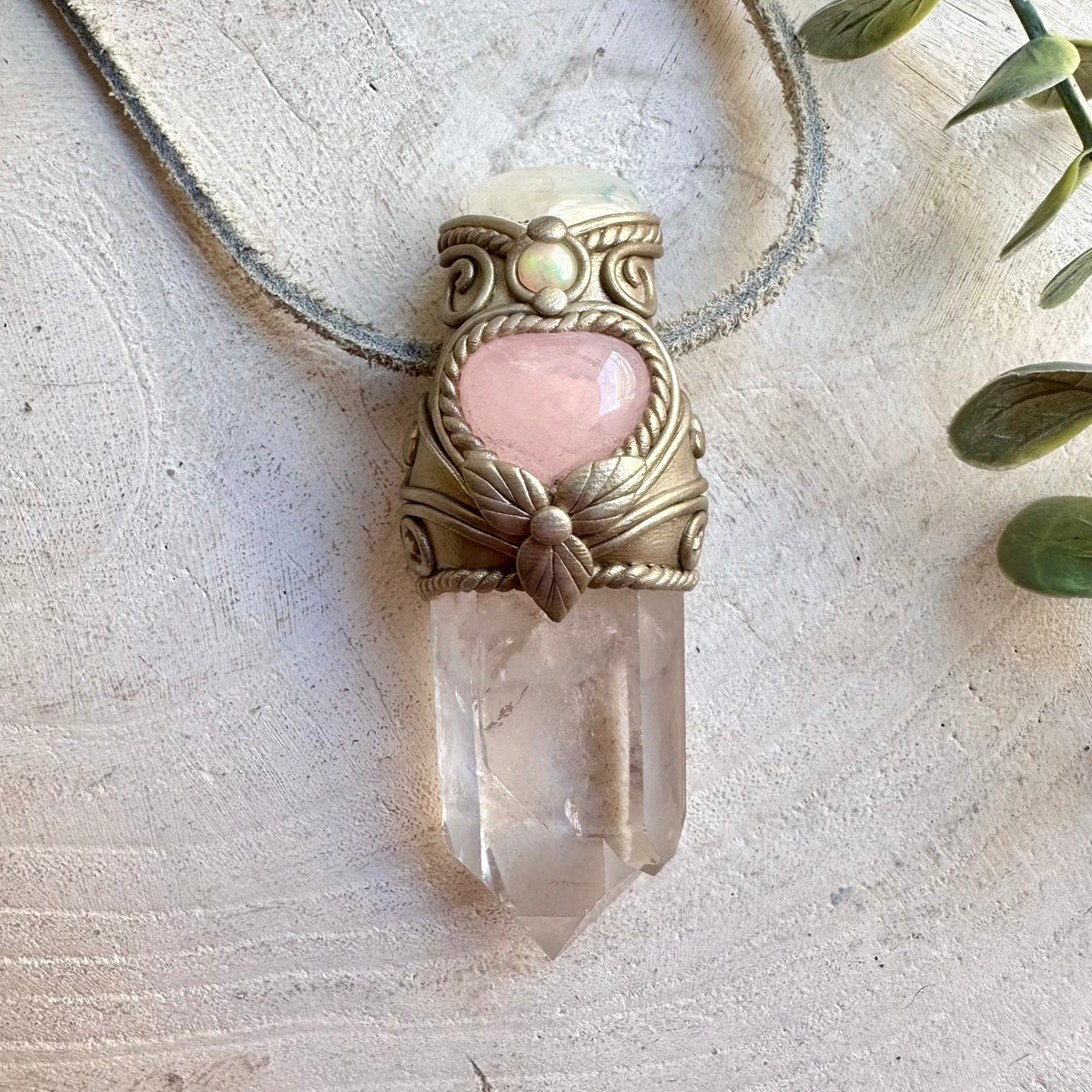 Handmade crystal wand necklace featuring a delicate Rose Quartz Heart alongside luminous Moonstone, natural Ethiopian Opal and Clear Quartz, this enchanting crystal wand necklace blends mystical beauty with powerful symbolic energy. A unique spiritual gemstone talisman for meditation, energy work, intention setting and everyday wear.