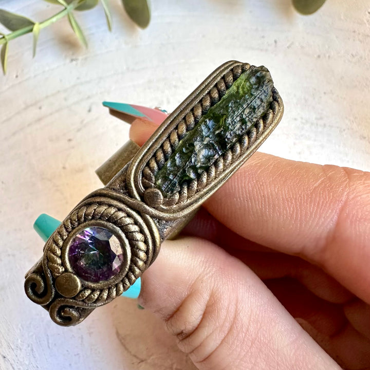 Close up of moldavite and mystic topaz ring
