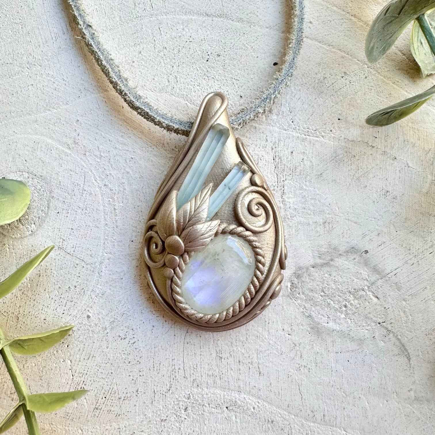 Metaphysical crystal jewelry handmade pendant with aquamarine crystals and moonstone
