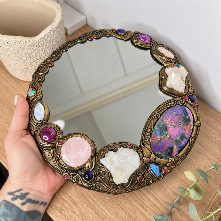 Handmade gemstone wall mirror with Apophyllite, Rose Quartz, Ruby, Morganite and Ethiopian Opal crystal accents.
