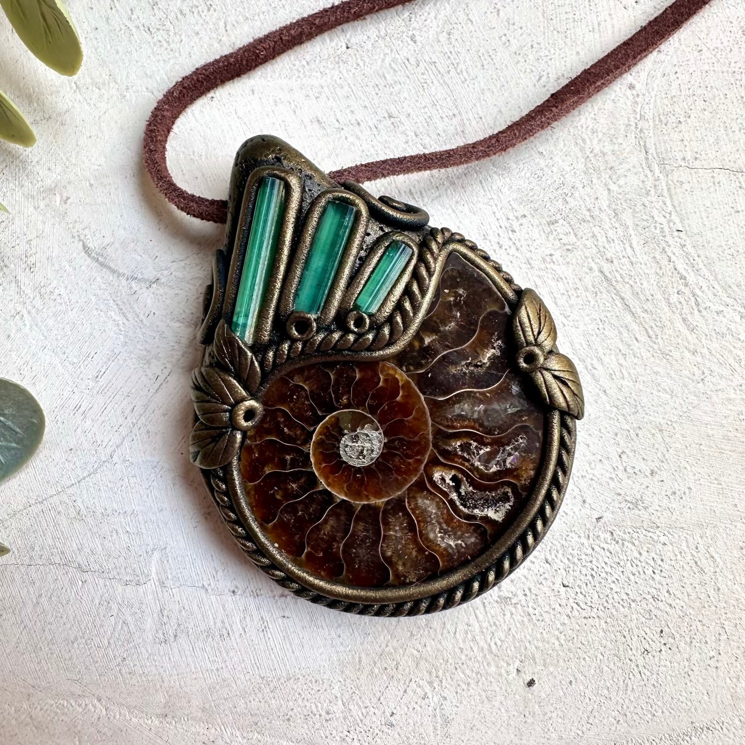 Earthy spiritual crystal pendant necklace with ammonite fossil and natural green tourmaline