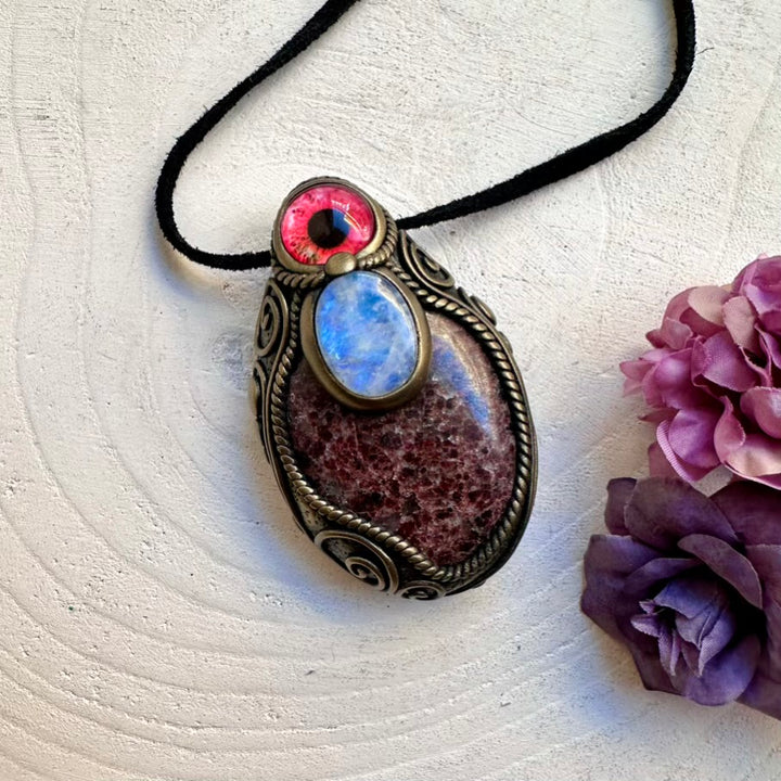 Spiritual protection crystal necklace featuring a large red Garnet stone and Rainbow Moonstone eye amulet, artisan handmade jewelry.