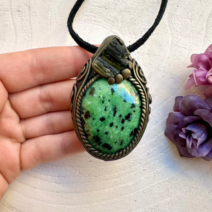 Spiritual amulet necklace featuring grounding Zoisite gemstone and raw imperfect Moldavite crystal, handmade with intention.
