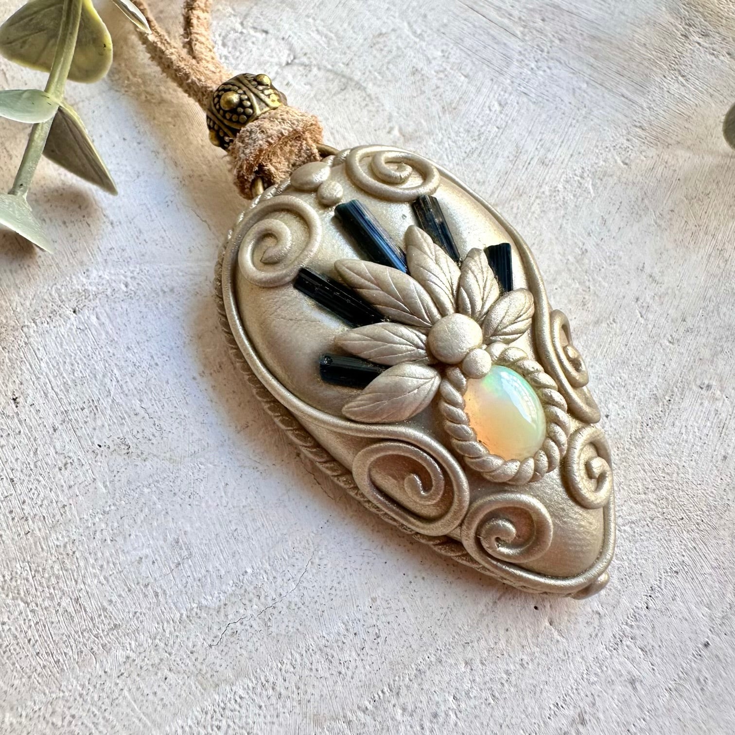 Handmade healing crystal necklace featuring Blue Tourmaline and iridescent Ethiopian Opal.