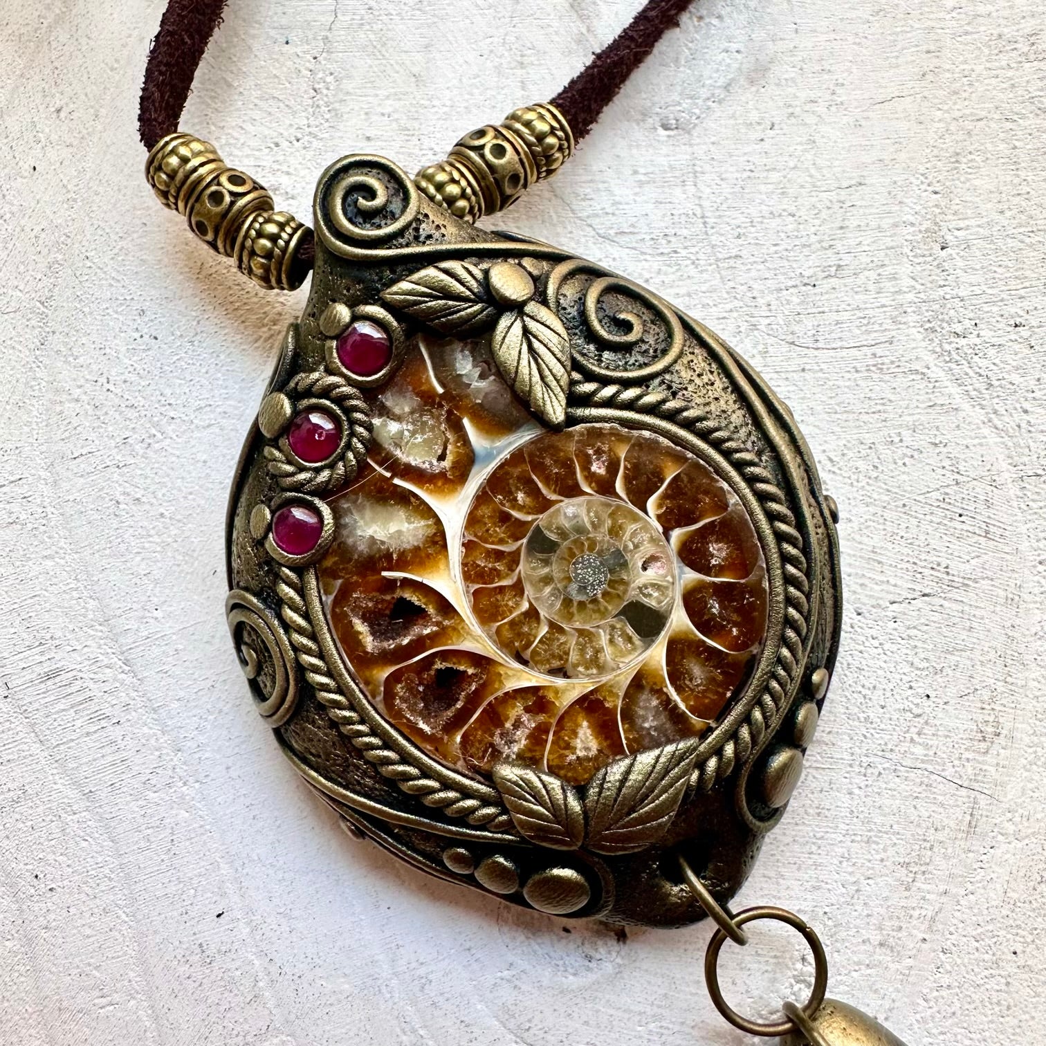 Natural fossil jewelry featuring Ammonite with shimmering Labradorite and vibrant Rhodolite Garnet.