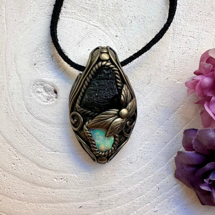Handmade healing amulet necklace with ethically sourced raw Moldavite and raw Ethiopian Opal crystal pendant for intuition and manifestation.