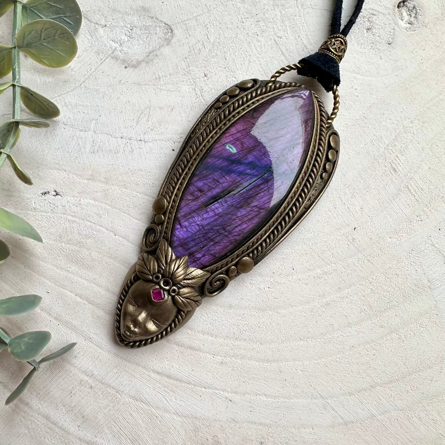 Large purple labradorite paired with ruby in a necklace