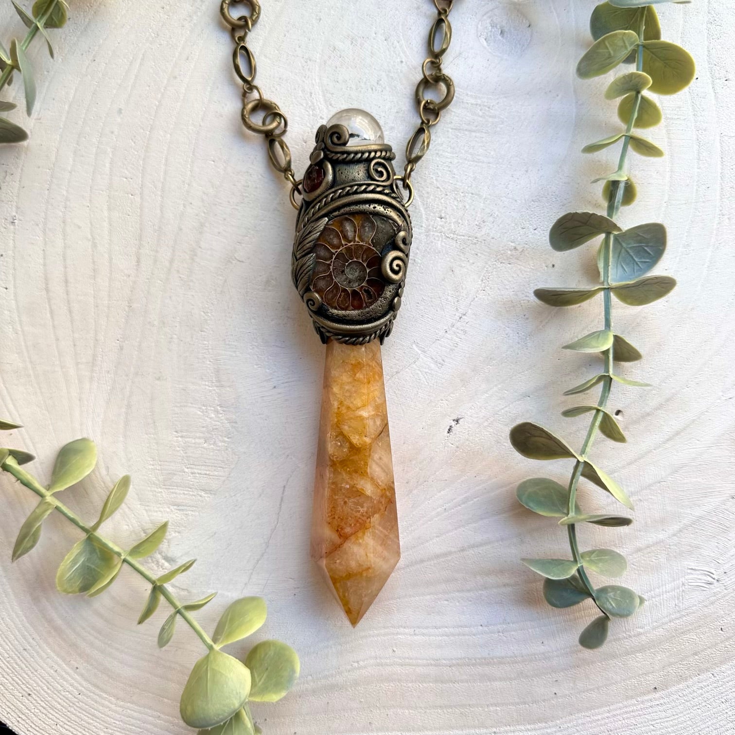 Spiritual ritual wand featuring golden healer and clear quartz