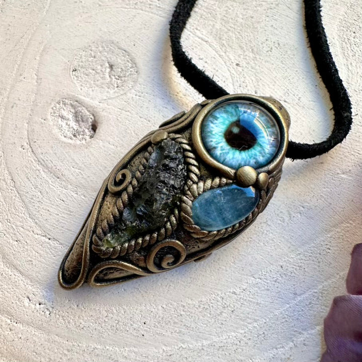 Spiritual talisman necklace featuring ethically sourced Moldavite and blue Aquamarine protective eye pendant.