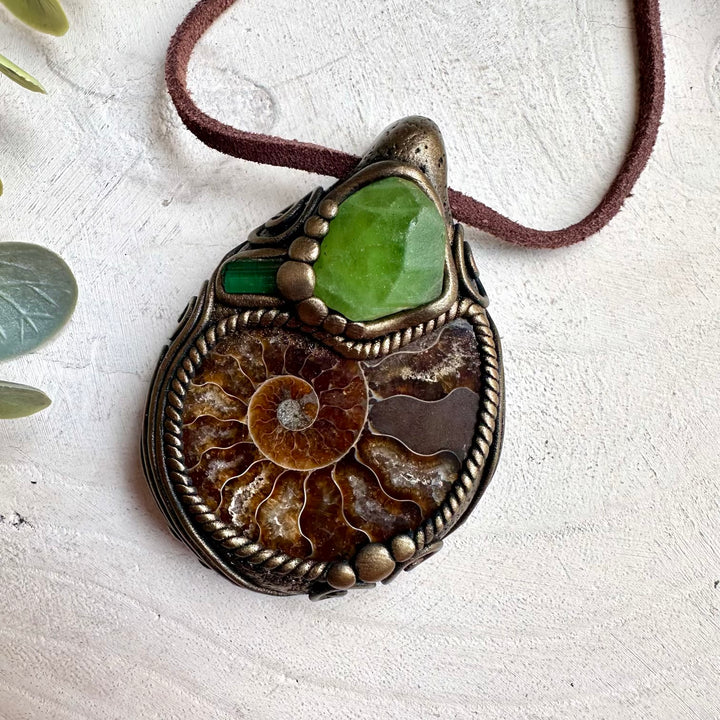 Raw ammonite healing crystal necklace featuring natural peridot and green tourmaline gemstones
