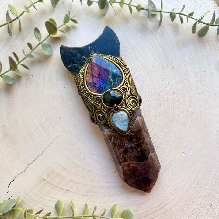 Unique crystal wand handcrafted with Super Seven Quartz and a beautiful Astrophyllite moon centerpiece.