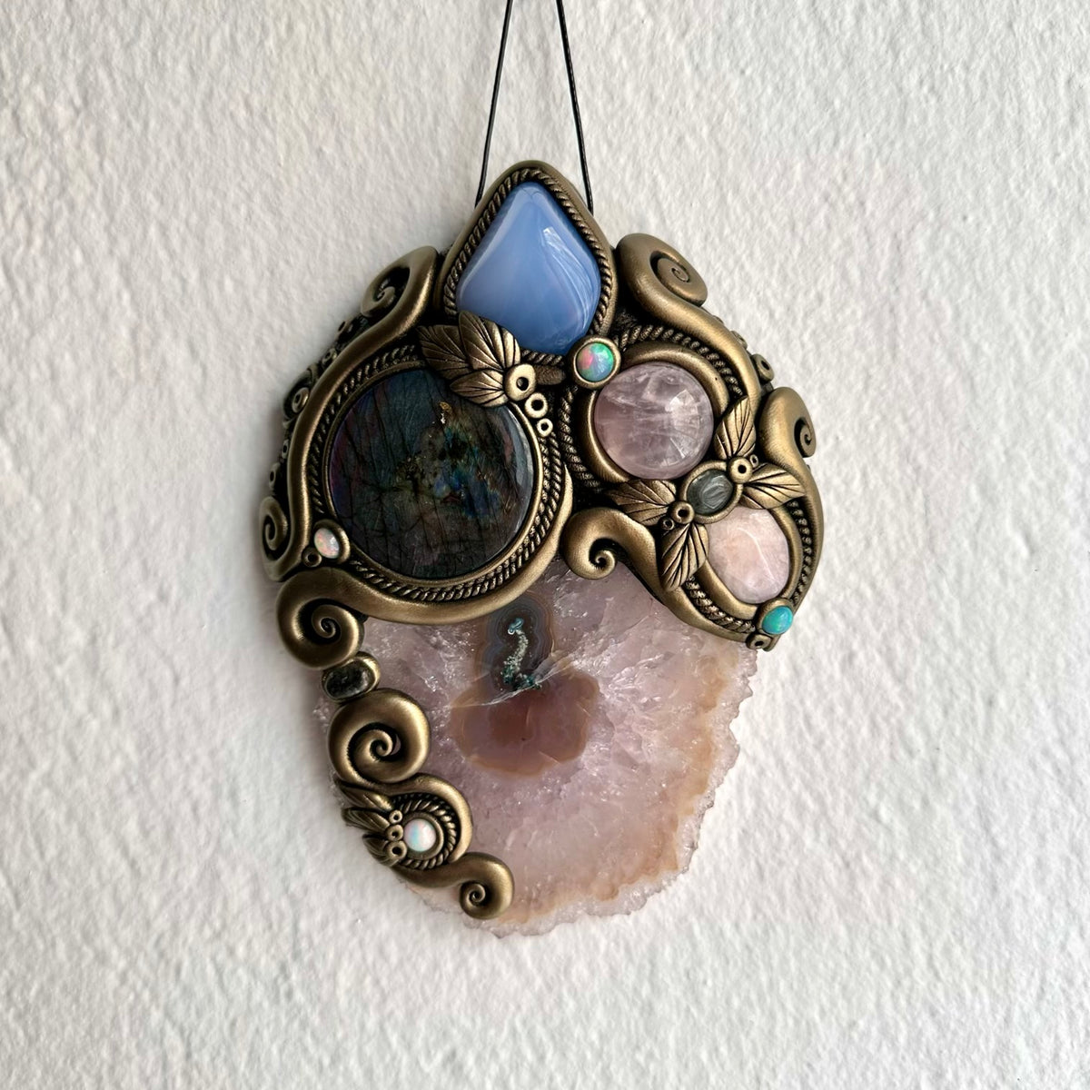 Colorful Ethiopian Opal and Clear Topaz add luminous accents to this handmade Amethyst and Labradorite gemstone wall art. Inspired by traditional crystal associations of intuition, peace, love, compassion, creativity, clarity, transformation and spiritual connection, this handmade gemstone wall decoration is perfect for collectors of natural crystals, healing crystal decor and unique artisan spiritual artwork.