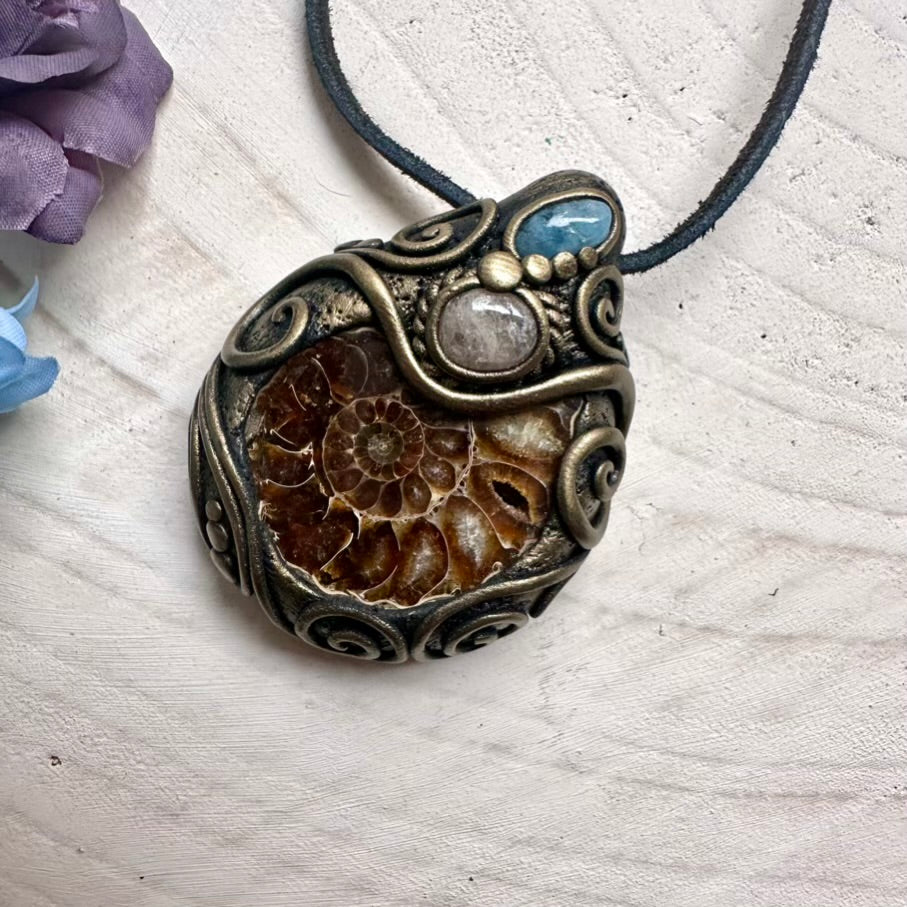 Spiritual crystal amulet featuring ancient Ammonite spiral, calming Aquamarine and heart-soothing pink Morganite, artisan handmade necklace.