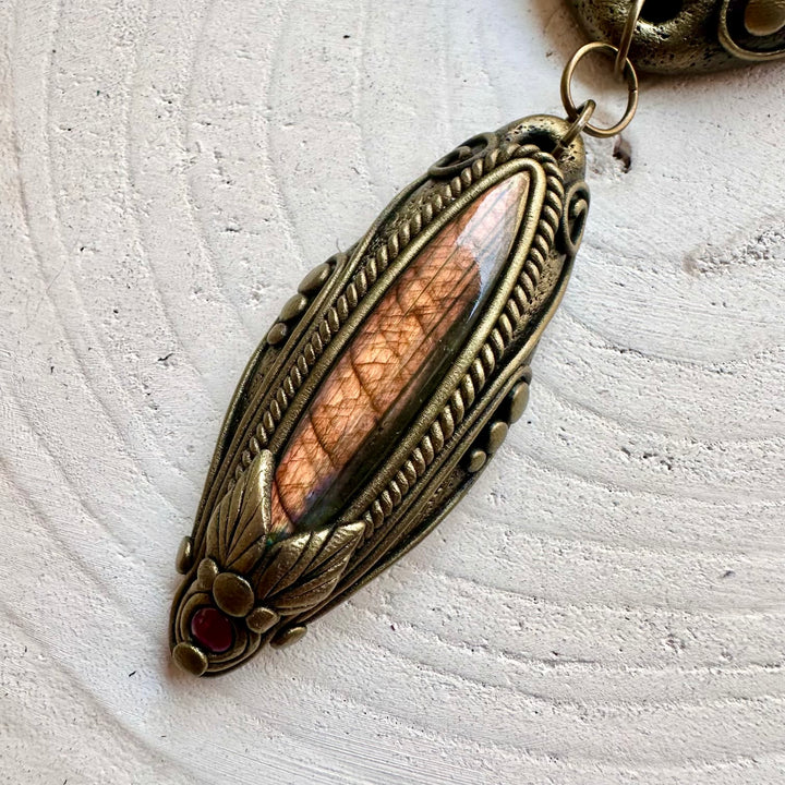 Elegant boho jewelry featuring Ammonite, Labradorite and Rhodolite Garnet in a handcrafted clay setting.