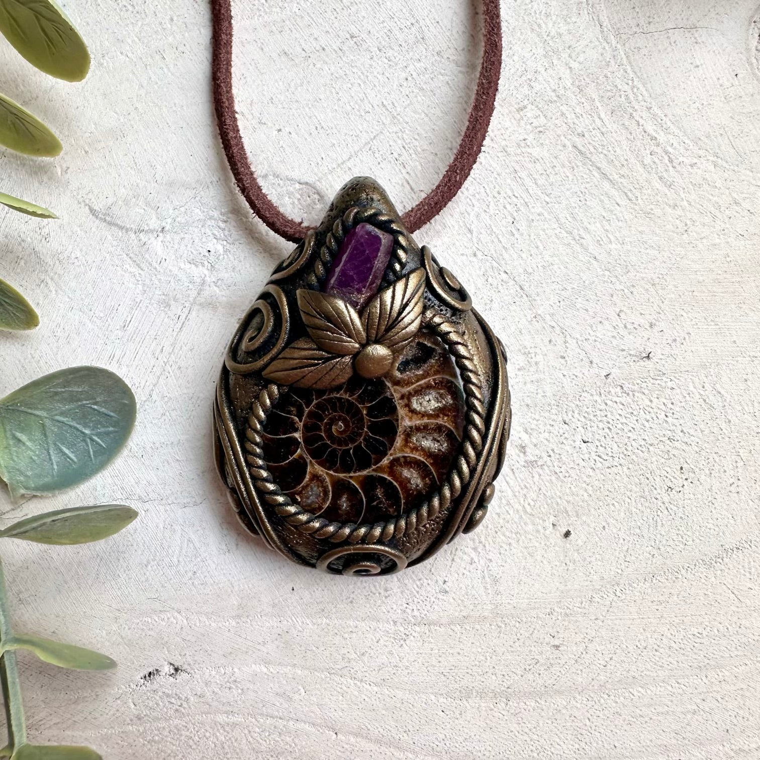 Spiritual jewelry necklace featuring natural Ammonite fossil and Ruby gemstone for love, vitality, and healing.