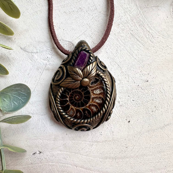 Spiritual jewelry necklace featuring natural Ammonite fossil and Ruby gemstone for love, vitality, and healing.