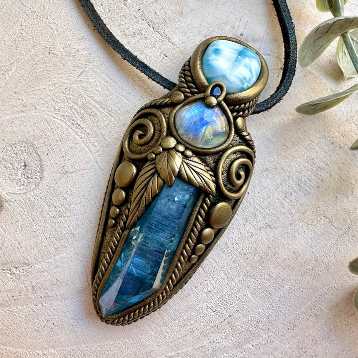 Spiritual healing necklace featuring Aqua Aura Quartz with Rainbow Moonstone and Blue Sapphire accents.