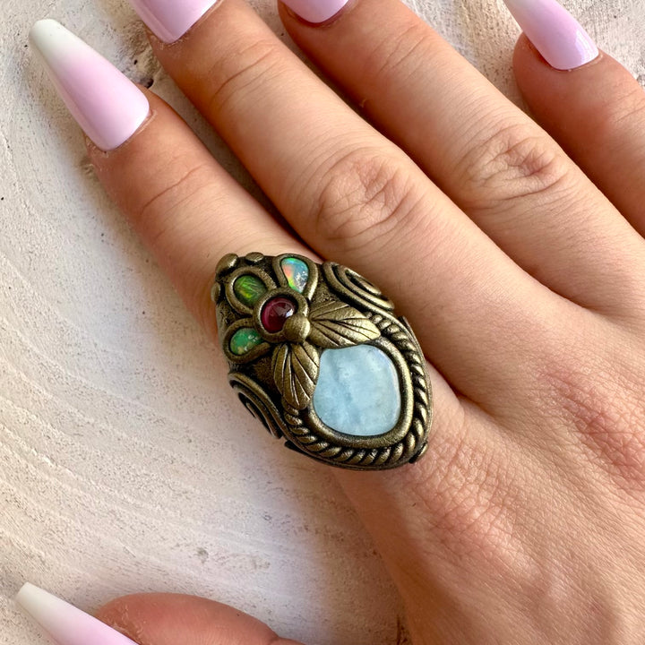 One of a kind handmade ring combining calming blue Aquamarine with colorful Opal and Garnet.