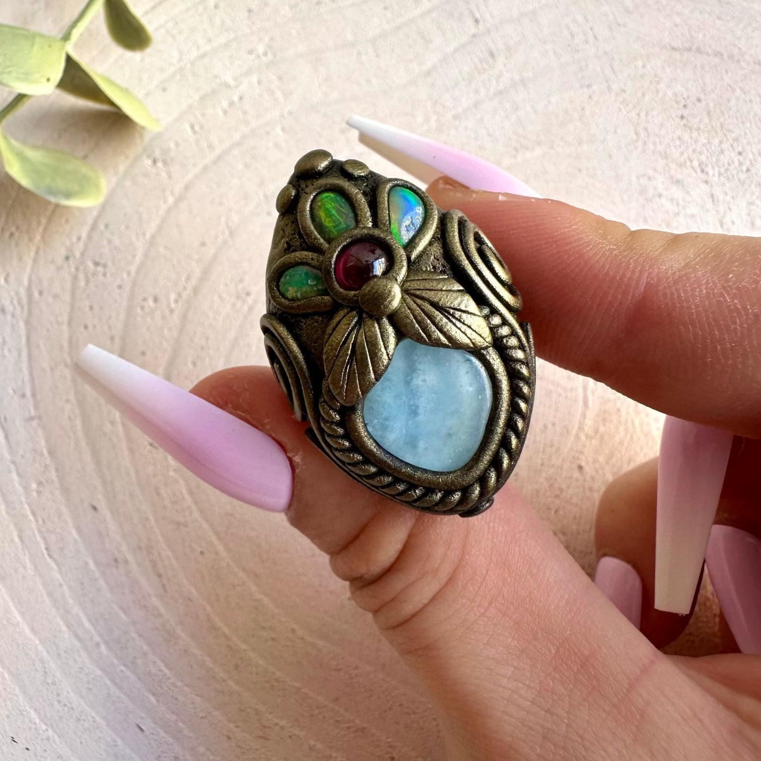 Handmade Aquamarine, Ethiopian Opal and Rhodolite Garnet ring, a one of a kind gemstone jewelry piece combining soft blue Aquamarine with luminous Opal flashes and rich red Garnet.
