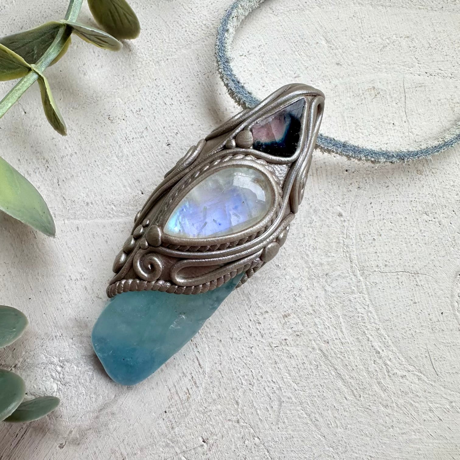 Aquamarine paired with rainbow moonstone and tourmaline slice in a necklace