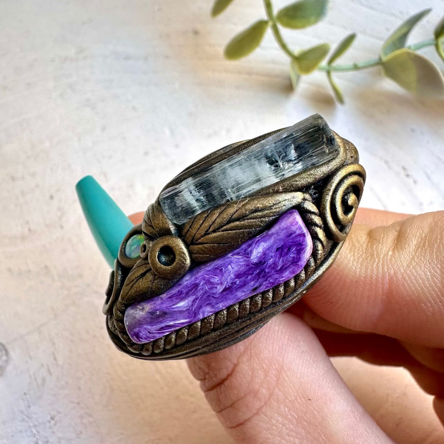 Aquamarine paired with charoite and opal in a ring