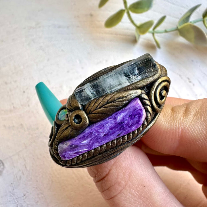 Aquamarine paired with charoite and opal in a ring