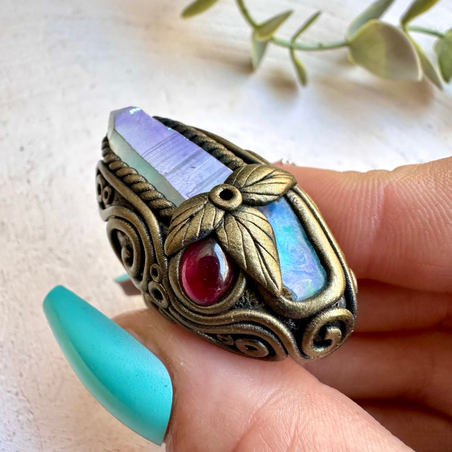 Angel aura quartz paired with raw Ethiopian opal in a ring