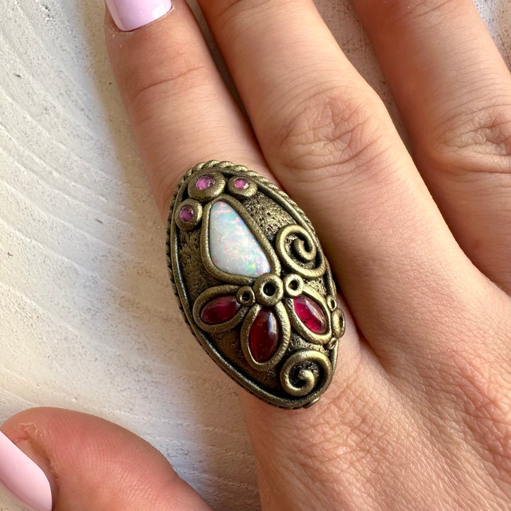 One of a kind artisan ring with luminous Australian Opal and deep red Garnet and Ruby.