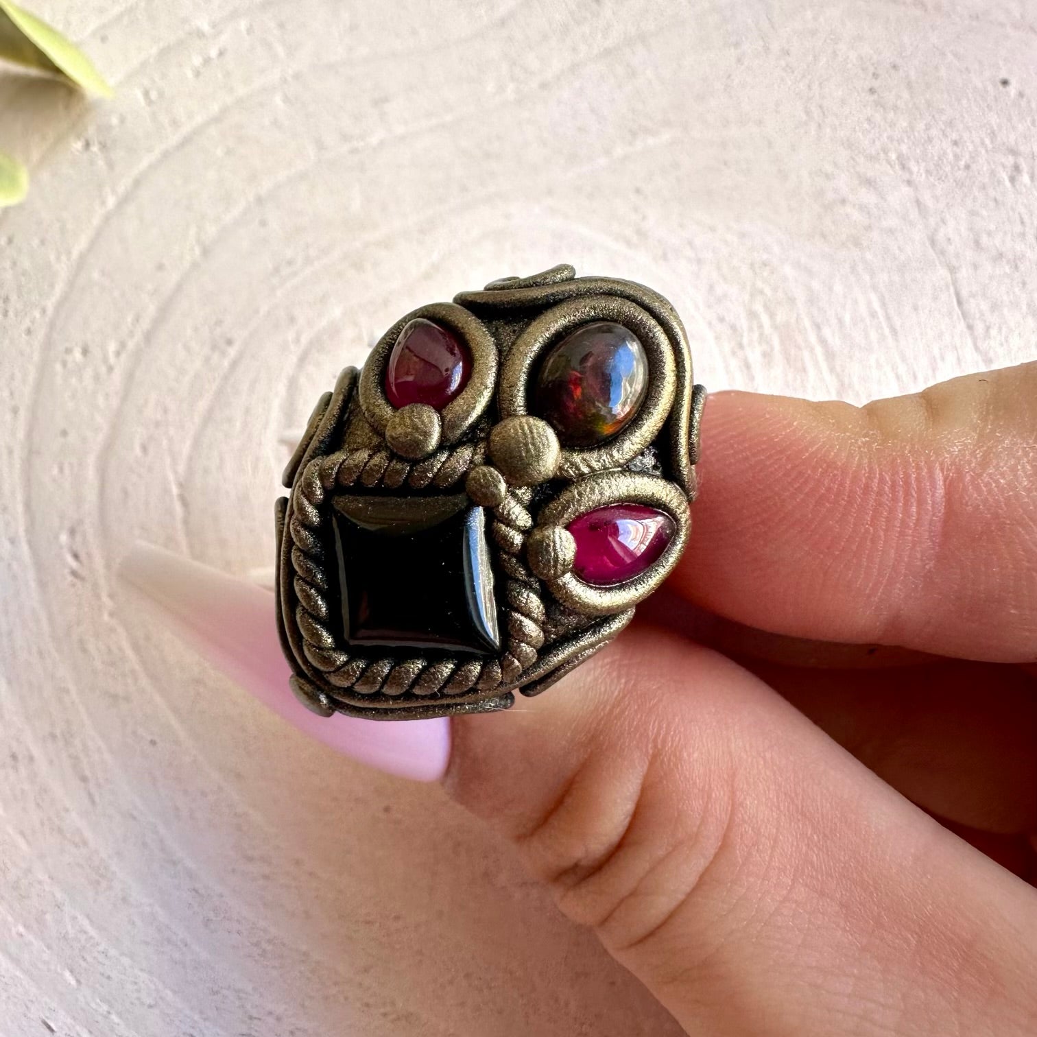 One of a kind handmade jewelry combining dark Onyx with iridescent Opal and vibrant Garnet.