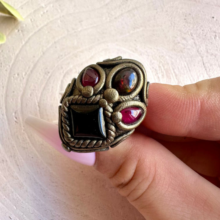 One of a kind handmade jewelry combining dark Onyx with iridescent Opal and vibrant Garnet.