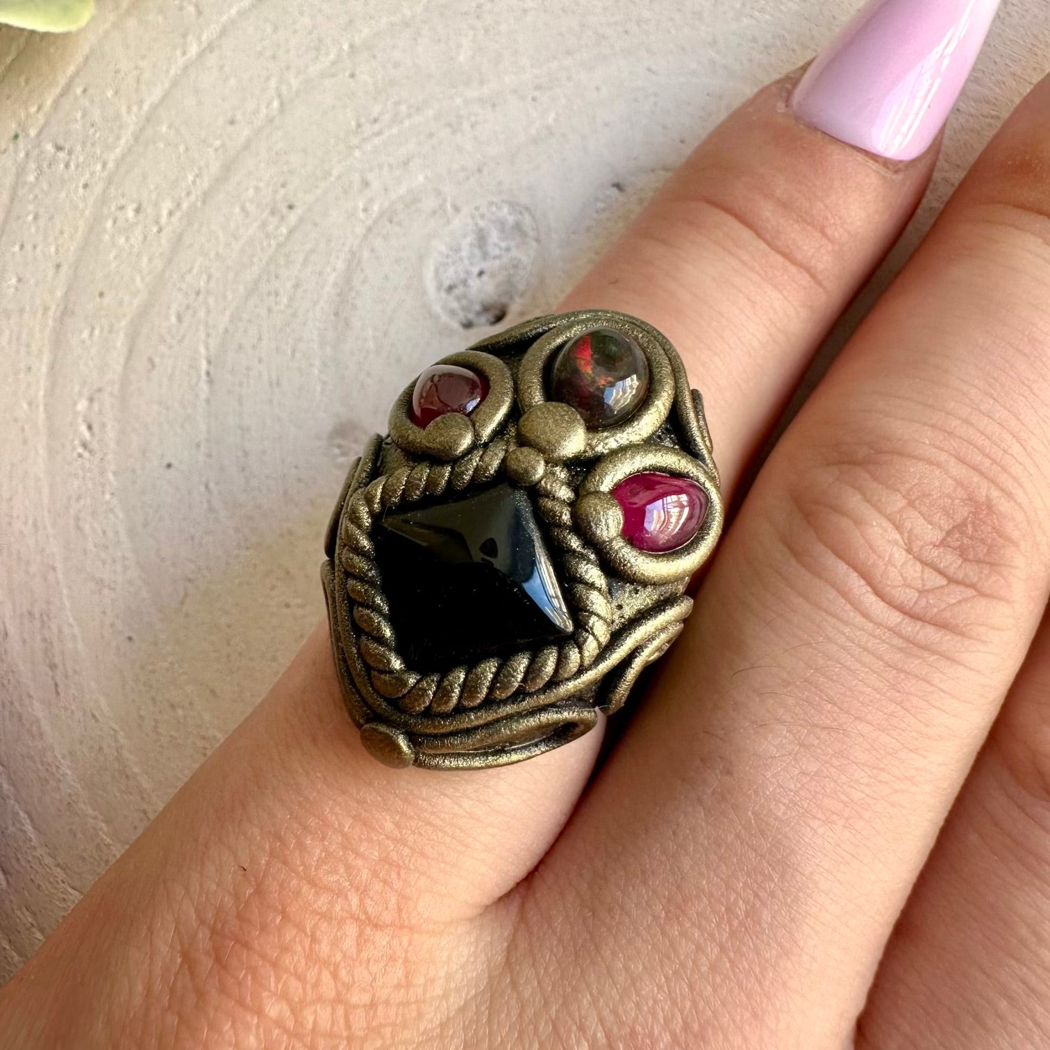Handmade Black Onyx, Black Ethiopian Opal and Rhodolite Garnet healing crystal ring, a one of a kind gemstone jewelry piece combining deep black Onyx with mesmerizing Opal flashes and rich red Garnet.