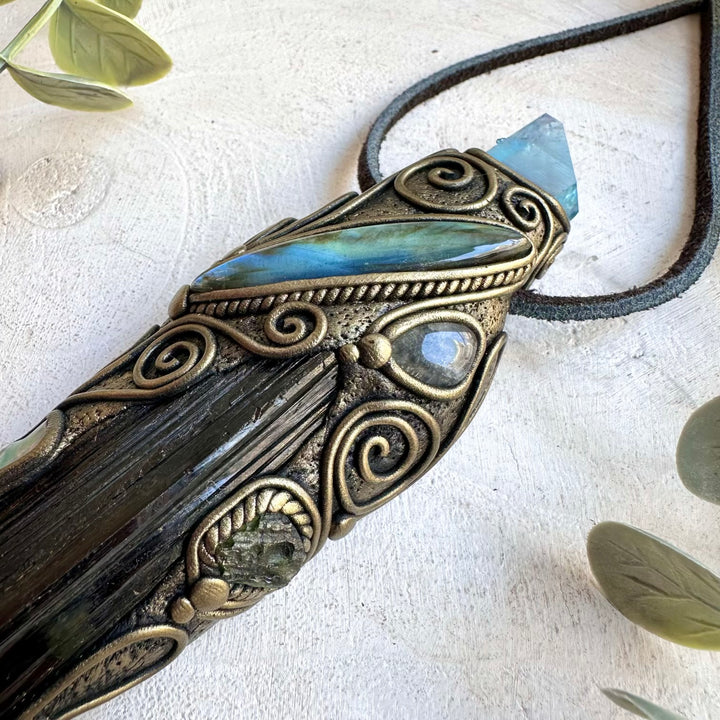Natural Black Tourmaline wand featuring Clear Topaz, Labradorite, Tibetan Turquoise and Moldavite gemstone details.