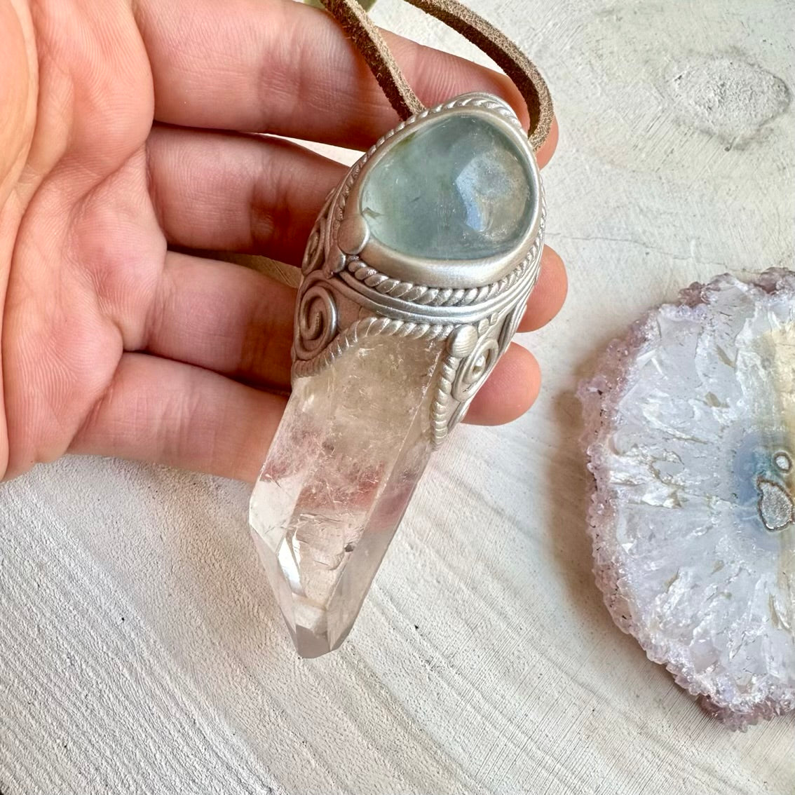 Spiritual pendant featuring long clear quartz crystal point