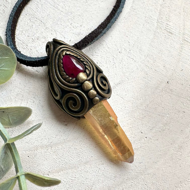 Crystal pendant necklace with Sunset Aura Quartz and Rhodolite Garnet designed for spiritual awakening and love energy.