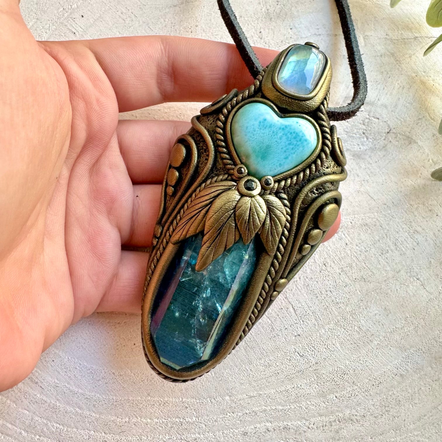One of a kind healing crystal wand featuring luminous Aqua Aura Quartz and a blue Larimar Heart.