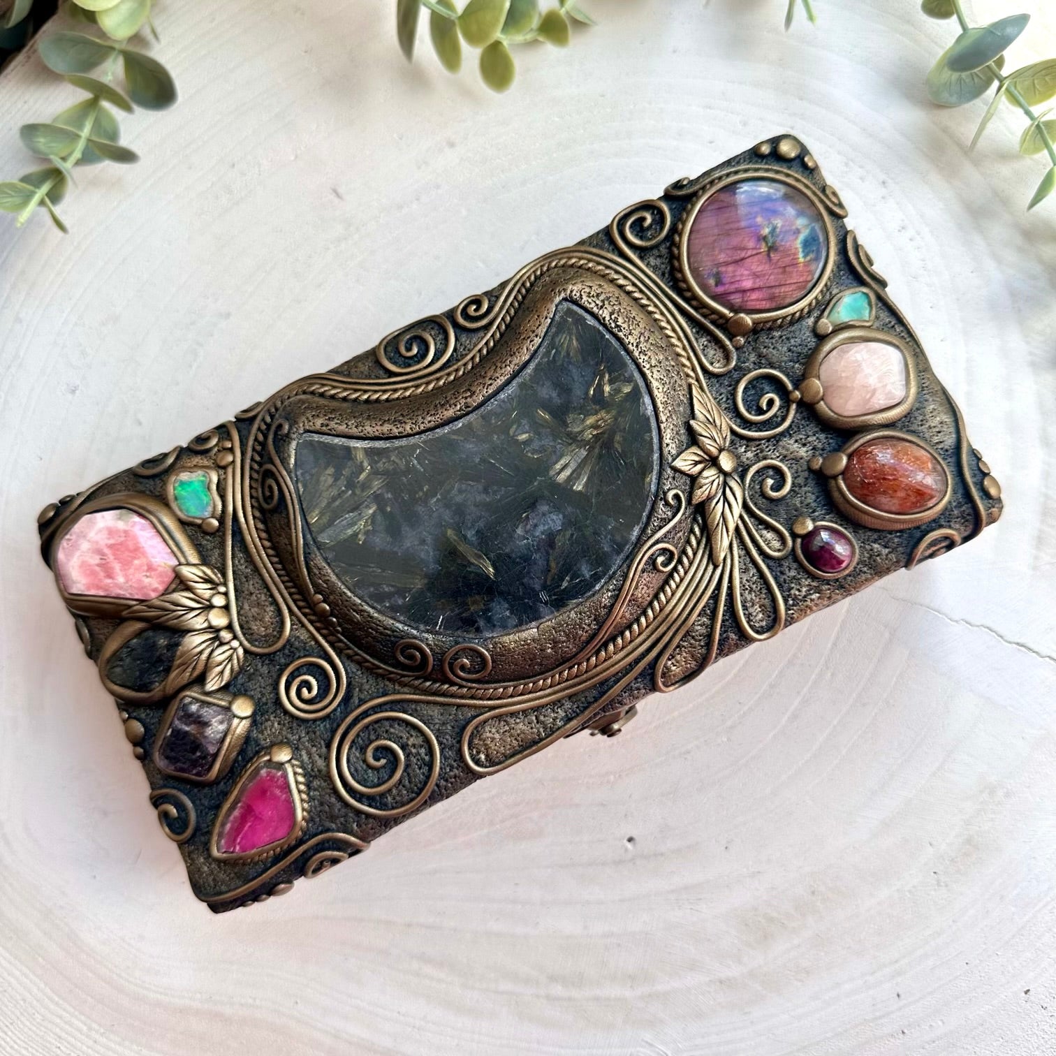 Handmade wooden box decorated with healing crystals including astrophyllite moon, morganite, and raw Ethiopian opal