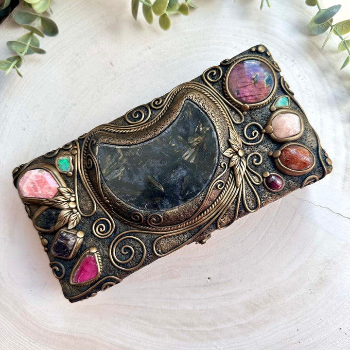 Handmade wooden box decorated with healing crystals including astrophyllite moon, morganite, and raw Ethiopian opal