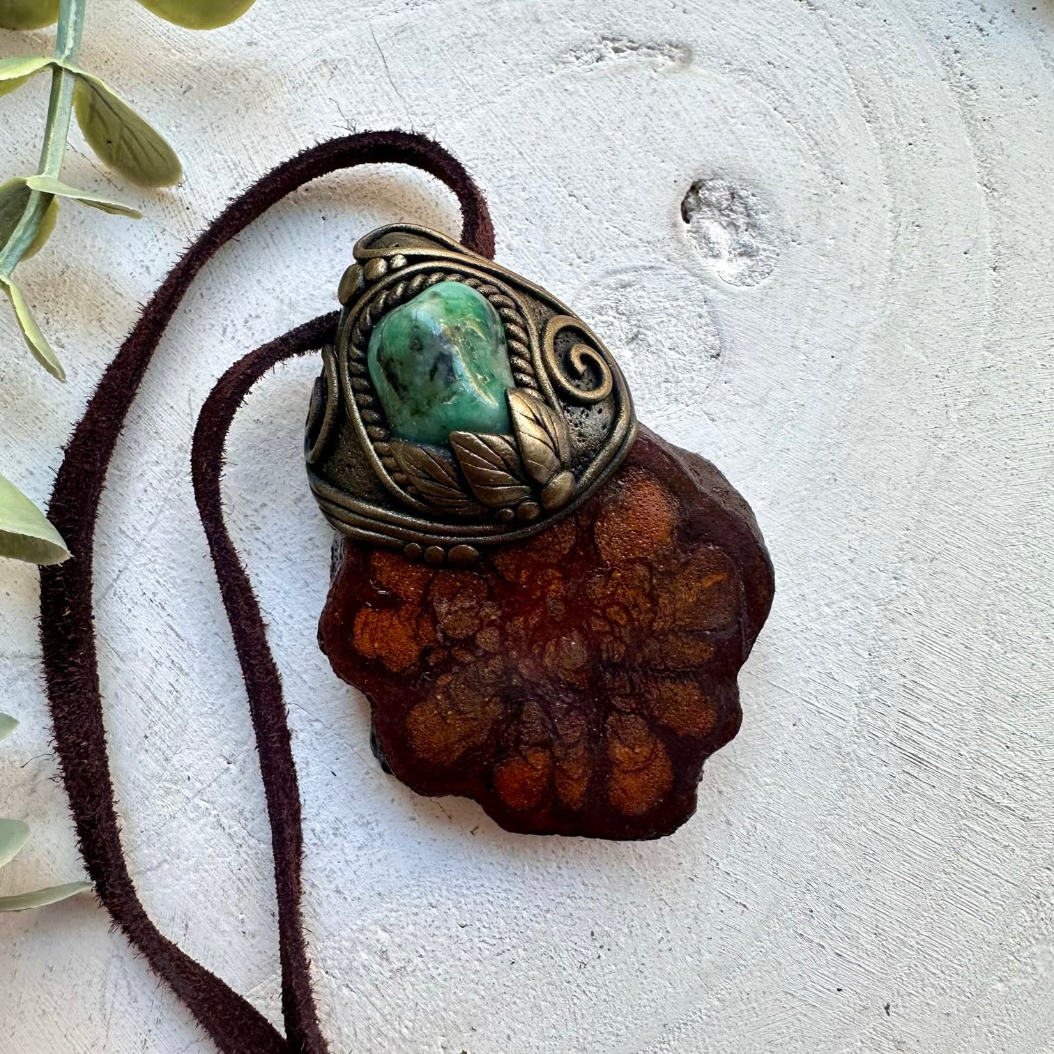 Emerald paired with ayahuasca vine in a unisex spiritual pendant necklace