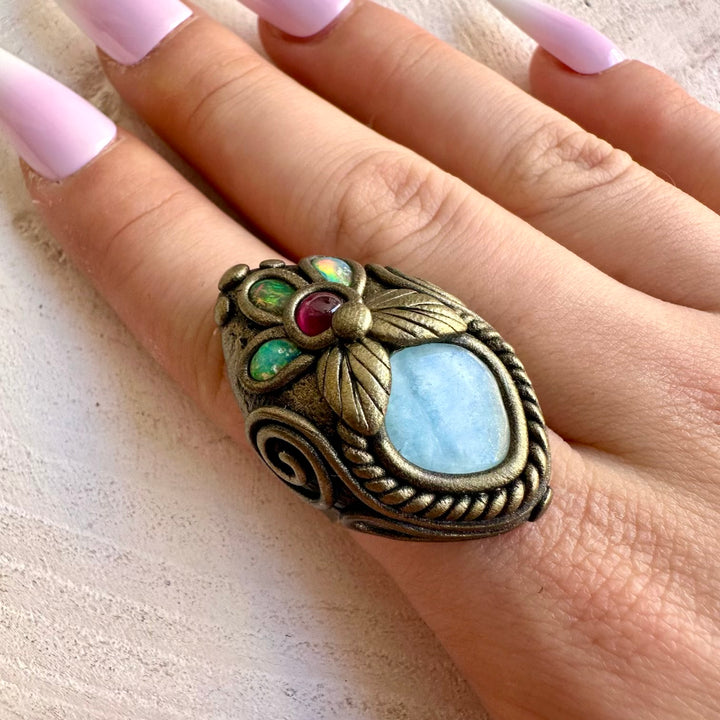 Handmade gemstone ring featuring Aquamarine, Ethiopian Opal and Rhodolite Garnet.